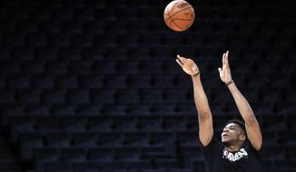 Milwaukee Bucks&#39; Giannis Antetokounmpo shoots during a training session ahead of the NBA basketball game against Charlotte Hornets, in Paris, Thursday, Jan. 23, 2020. (AP Photo/Thibault Camus)