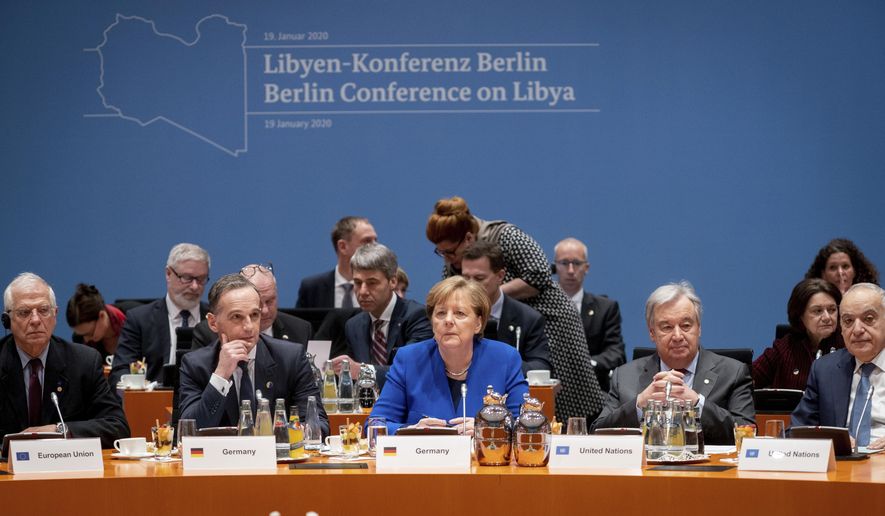 German Foreign Minister Heiko Maas, second left, German Chancellor Angela Merkel, center, and Antonio Guterres, second right, Secretary-General of the United Nations, attend a conference on Libya at the chancellery in Berlin, Germany, Sunday, Jan. 19, 2020. (Kay Nietfeld/DPA via AP, Pool)