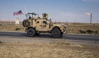 In this Oct. 28, 2019, photo, U.S. forces patrol Syrian oil fields, in eastern Syria. (AP Photo/Baderkhan Ahmad) **FILE**