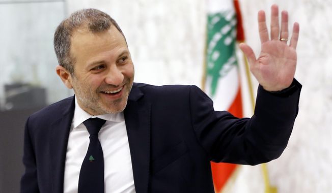 FILE - This Feb. 2, 2019 file photo, Lebanese Foreign Minister Gebran Bassil arrives to attend the first meeting of the Lebanese cabinet at the Presidential Palace in Baabda, east of Beirut, Lebanon. Lebanese are campaigning against the participation of their acting foreign minister in the prestigious World Economic Forum in Davos, saying Bassil, who was the target of popular anger in the ongoing nationwide protests,  should not represent them on the international stage. (AP Photo/Bilal Hussein, File)