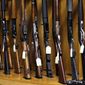 In this Oct. 20, 2017, file photo, rifles are lined up and ready to be auctioned at Johnny&#39;s Auction House, where the company handles gun sales for about a half dozen police departments and the Lewis County Sheriff&#39;s Office, in Rochester, Wash. (AP Photo/Elaine Thompson, File)
