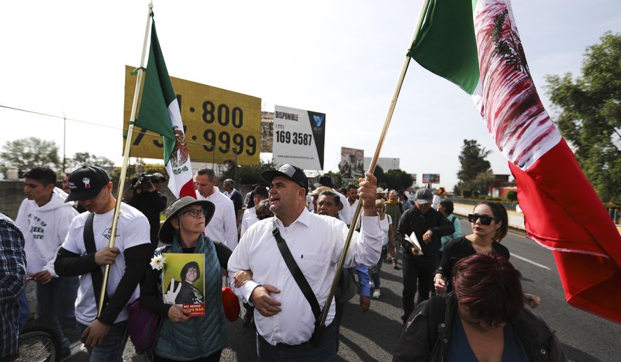 Julian LeBaron carries a Mexican flag during a protest against violence called &amp;quot;Walk for Peace&amp;quot; as the group leaves Cuernavaca, Mexico, Thursday, Jan. 23, 2020, with Mexico City as their destination. Activist and poet Javier Sicilia is leading his second march against violence in Mexico, this time accompanied by members of the LeBaron family, and plan to reach Mexico&#x27;s National Palace on Sunday. (AP Photo/Eduardo Verdugo)