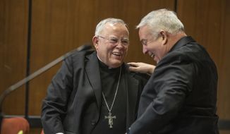 Archbishop Charles J. Chaput, left, and Archbishop-elect Nelson J. Perez, right, share a happy moment after they embraced during the press conference announcing Perez as the Archbishop-elect of Philadelphia on Thursday, January 23, 2020. (Michael Bryant/The Philadelphia Inquirer via AP) ** FILE **