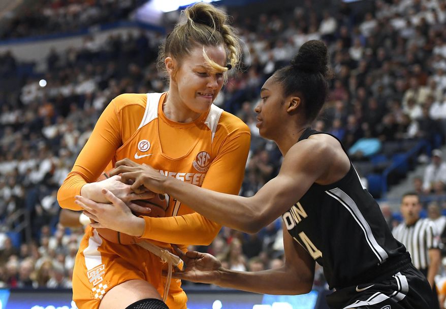 Tennessee&#39;s Lou Brown, left, and Connecticut&#39;s Aubrey Griffin fight for possession of the ball in the first half of an NCAA college basketball game, Thursday, Jan. 23, 2020, in Hartford, Conn. (AP Photo/Jessica Hill)