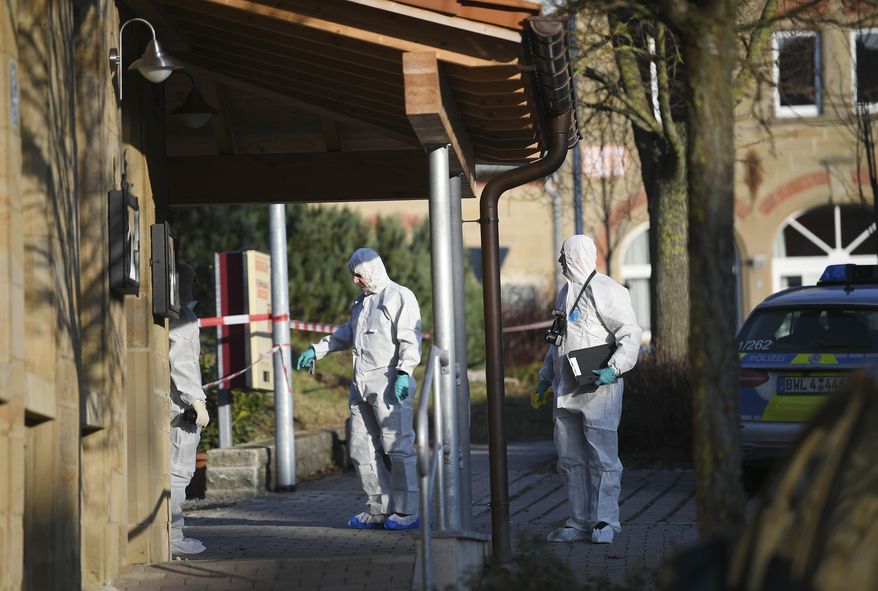 Police at the scene after shots were fired in Rot am See, Germany, Friday, Jan. 24, 2020. Six people have been killed and several were injured in a shooting in the southwestern German town of Rot am See, police said Friday. A suspect has been arrested and no further suspects are believed to be at large, Aalen police said. (Sebastian Gollnow/dpa via AP)