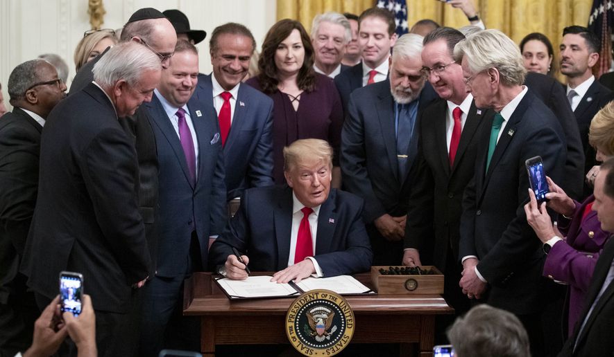 President Donald Trump pauses while signing H.R. 2476, Securing American Nonprofit Organizations Against Terrorism Act of 2019, with a bipartisan group of the nation&#x27;s mayors in the East Room of the White House, Friday, Jan. 24, 2020, in Washington. (AP Photo/Alex Brandon) **FILE**