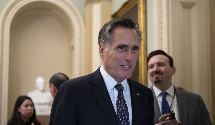 Sen. Mitt Romney, R-Utah, arrives at the Senate for a Republican lunch before work resumes in the impeachment trial of President Donald Trump on charges of abuse of power and obstruction of Congress, in Washington, Friday, Jan. 24, 2020. (AP Photo/J. Scott Applewhite)