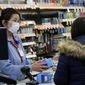 A sales clerk at a pharmacy rings up a purchase of face masks as fears of the coronavirus continues Friday, Jan 24, 2020, in Chicago. A Chicago woman has become the second U.S. patient diagnosed with the dangerous new virus from China, health officials announced Friday. (Antonio Perez/Chicago Tribune via AP) **FILE**