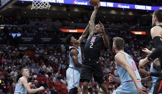 Los Angeles Clippers forward Kawhi Leonard (2) drives to the basket as Miami Heat forward Jimmy Butler defends during the first half of an NBA basketball game, Friday, Jan. 24, 2020, in Miami. (AP Photo/Lynne Sladky)