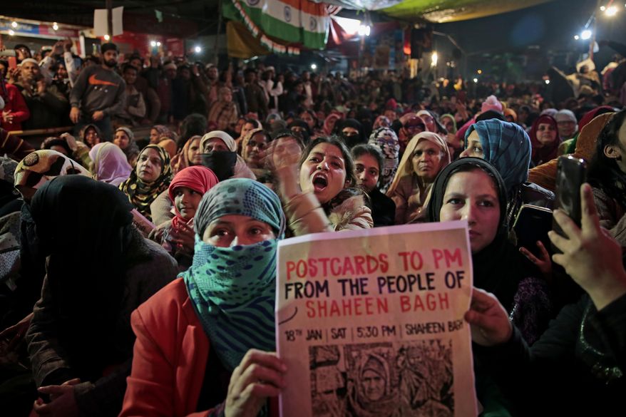 In this Saturday, Jan. 18, 2020 photo, women protesters shout slogans at the protest site at Shaheen Bagh area in New Delhi, India. Muslim women are transcending the confines of their homes to lay claim to the streets of this nondescript Muslim neighborhood in the Indian capital and slowly transforming it into a nerve center of resistance against a new citizenship law that has unleashed protests across the country. The women, sitting in the middle of a major highway, have taken turns maintaining an around the clock sit-in for more than a month. They sing songs of protest and chant anti-government slogans, some cradling babies, others laying down rugs to make space for more people to sit. (AP Photo/Altaf Qadri)