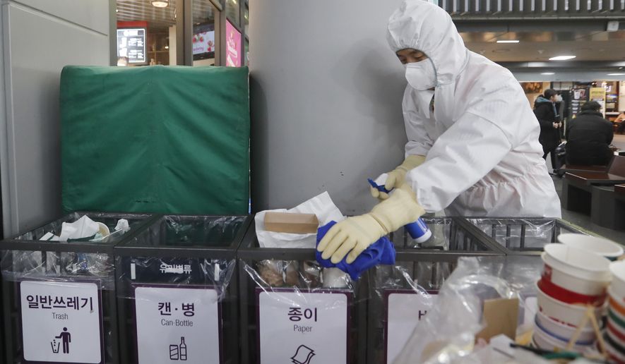 FILE - In this Jan. 24, 2020, file photo an employee works to prevent a new coronavirus at Suseo Station in Seoul, South Korea. On Friday, Jan. 24, 2020, The Associated Press reported on the false claim that the coronavirus outbreak spreading from China is nothing new and that patents were created around it years ago. The patents being shared online are not related to the new respiratory virus that has sickened hundreds of people in China and caused concern around the world. (AP Photo/Ahn Young-joon, File)