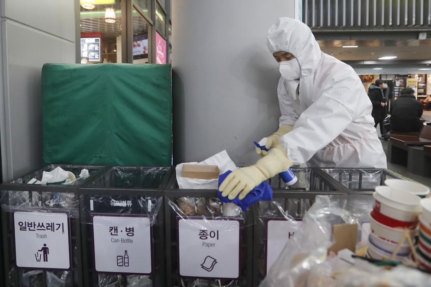 FILE - In this Jan. 24, 2020, file photo an employee works to prevent a new coronavirus at Suseo Station in Seoul, South Korea. On Friday, Jan. 24, 2020, The Associated Press reported on the false claim that the coronavirus outbreak spreading from China is nothing new and that patents were created around it years ago. The patents being shared online are not related to the new respiratory virus that has sickened hundreds of people in China and caused concern around the world. (AP Photo/Ahn Young-joon, File)