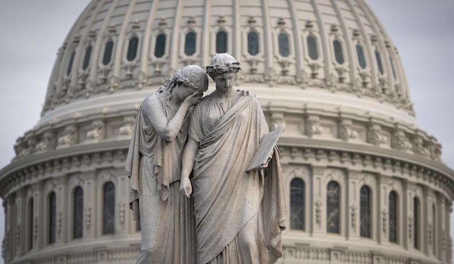The Capitol Dome looms behind the Peace Monument statue as the impeachment trial of President Donald Trump on charges of abuse of power and obstruction of Congress is conducted inside the Senate, in Washington, Thursday, Jan. 23, 2020. (AP Photo/J. Scott Applewhite)