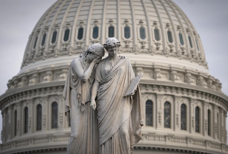 The Capitol Dome looms behind the Peace Monument statue as the impeachment trial of President Donald Trump on charges of abuse of power and obstruction of Congress is conducted inside the Senate, in Washington, Thursday, Jan. 23, 2020. (AP Photo/J. Scott Applewhite)