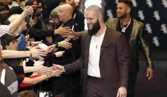 Chicago White Sox&#39;s Dallas Keuchel, center, is welcomed by fans after he was introduced during the team&#39;s annual fan convention Friday, Jan. 24, 2020, in Chicago. (AP Photo/Charles Rex Arbogast)