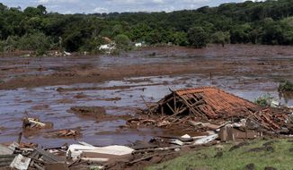 FILE - In this  Jan. 25, 2019 file photo, a structure lays in ruins after a dam collapsed near Brumadinho, Brazil. The wave of mud and debris that on Jan. 25, 2019 buried the equivalent of 300 soccer pitches and killed 270 people, continues to barrel over residents’ minds, the local economy and the environment, one year later. (Leo Drumond/Nitro via AP, File)