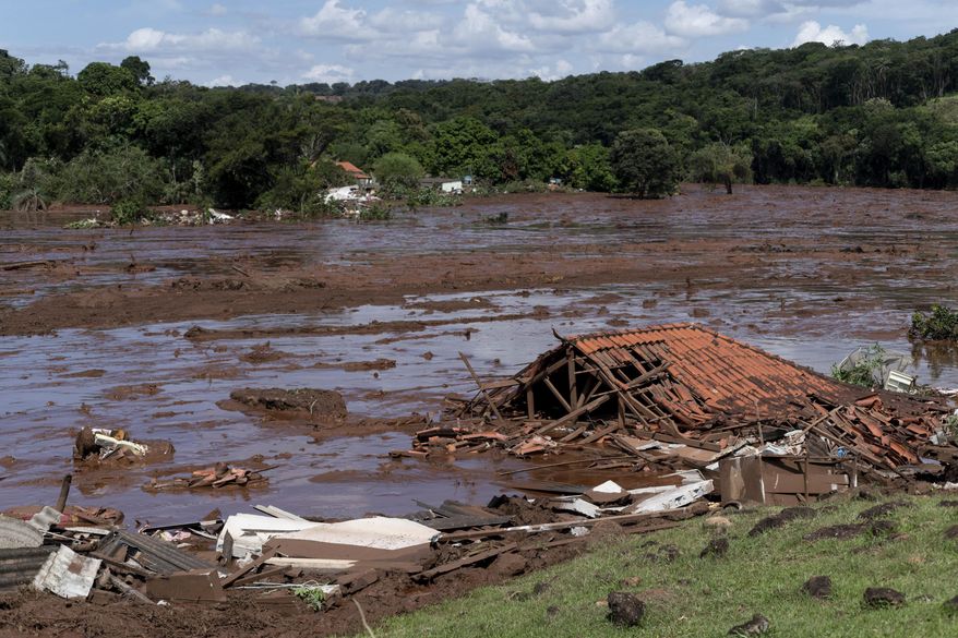 FILE - In this  Jan. 25, 2019 file photo, a structure lays in ruins after a dam collapsed near Brumadinho, Brazil. The wave of mud and debris that on Jan. 25, 2019 buried the equivalent of 300 soccer pitches and killed 270 people, continues to barrel over residents’ minds, the local economy and the environment, one year later. (Leo Drumond/Nitro via AP, File)