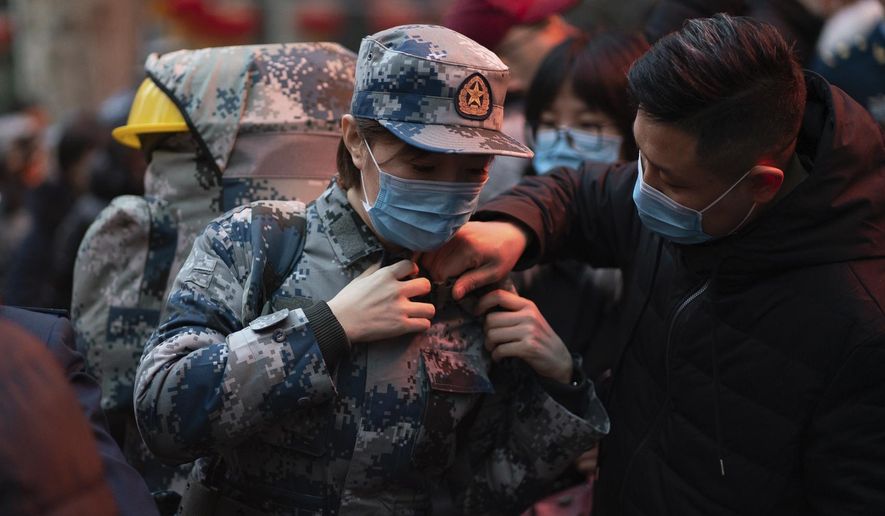 In this photo taken Jan 24, 2020 and released by Xinhua News Agency, a military medic from the Air Force Medical University prepares to leave for Wuhan from Xi&#x27;an, capital of northwestern China&#x27;s Shaanxi Province. The Chinese military dispatched medical staff, some with experience in past outbreaks including SARS and Ebola, to help treat the many patients hospitalized with viral pneumonia, Xinhua reported. (Zhang Haopeng/Xinhua via AP)