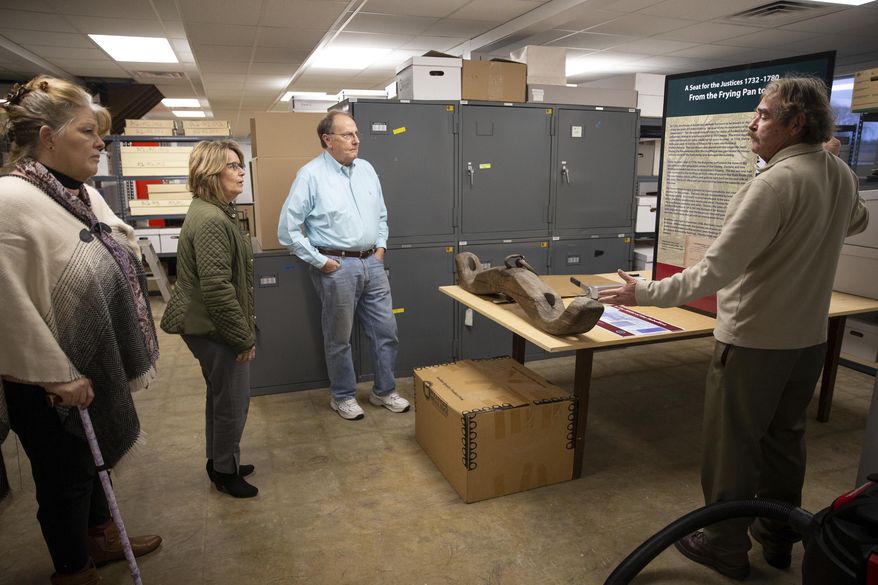 J. Terry Dougherty, curator of the Spotsylvania County Museum, gives a brief tour of the museum's collection to (from left) Karen Robison, Linda Struebing and Dennis Gallahan at the First Day of Chancellorsville Park in Spotsylvania, Va. on Wednesday, Jan. 15, 2020.(Mike Morones/The Free Lance-Star via AP)