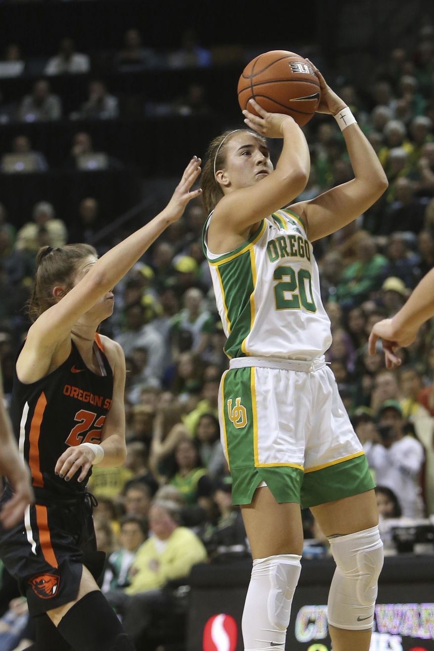Oregon&#39;s Sabrina Ionescu, right, shoots ahead of Oregon State&#39;s Kat Tudor during the first quarter of an NCAA college basketball game in Eugene, Ore., Friday, Jan. 24, 2020. (AP Photo/Chris Pietsch)