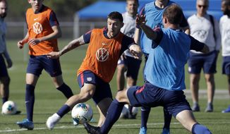 Paul Arriola, center, a forward on the U.S. Men&#39;s National Soccer team, kicks the ball during a scrimmage Wednesday, Jan. 8, 2020, in Bradenton, Fla. The team moved its training camp from Qatar to Florida in the wake of Iran&#39;s top military commander being killed during a U.S. airstrike in the Middle East. (AP Photo/Chris O&#39;Meara) **FILE**