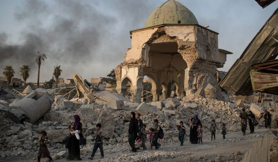 Civilians fled as Iraqi forces advanced on Mosul in 2017 after oppressive occupation by the Islamic State. Shifa al-Nima, a Muslim religious scholar, said he “issued fatwas to confiscate houses of displaced people and permitted ISIS fighters to blow up mosques.” (Associated Press)