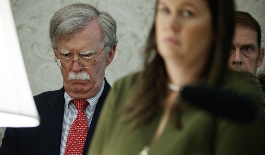 National security adviser John Bolton listens to a meeting between President Donald Trump and Canadian Prime Minister Justin Trudeau in the Oval Office of the White House, Thursday, June 20, 2019, in Washington. White House press secretary Sarah Sanders is at right.  (AP Photo/Evan Vucci)