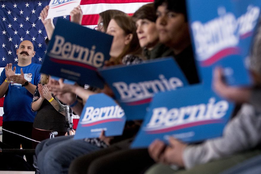 Members of the audience applaud as Democratic presidential candidate Sen. Bernie Sanders, I-Vt., speaks at a campaign stop at La Poste, Sunday, Jan. 26, 2020, in Perry, Iowa. (AP Photo/Andrew Harnik)