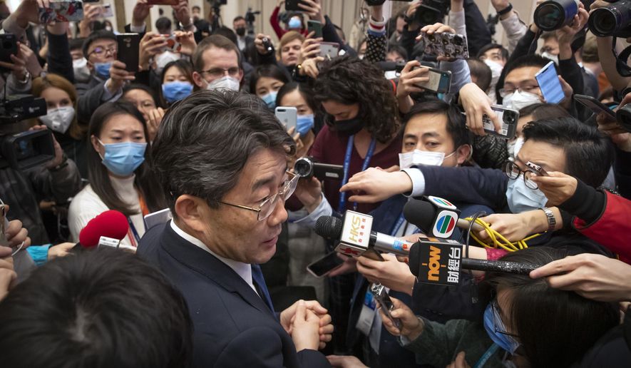 Gao Fu, bottom, the head of the Chinese Center for Disease Control and Prevention (CDC), speaks to journalists after a press conference about a virus outbreak at the State Council Information Office in Beijing, Sunday, Jan. 26, 2020. The new virus accelerated its spread in China, and the U.S. Consulate in the epicenter of the outbreak, the central city of Wuhan, announced Sunday it will evacuate its personnel and some private citizens aboard a charter flight. (AP Photo/Mark Schiefelbein) ** FILE **