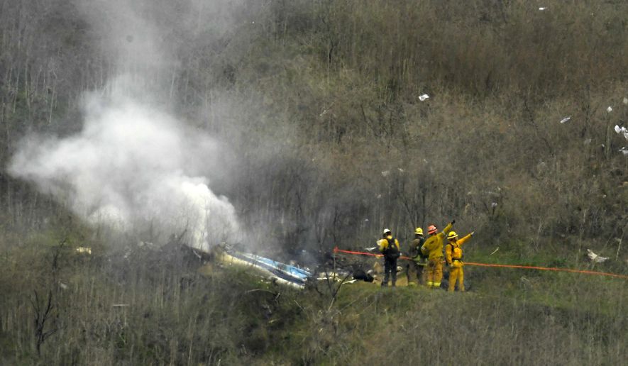 Firefighters work the scene of a helicopter crash where former NBA star Kobe Bryant died, Sunday, Jan. 26, 2020, in Calabasas, Calif. (AP Photo/Mark J. Terrill)