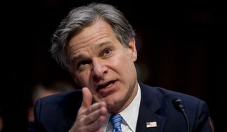 In this Nov. 5, 2019, file photo, FBI Director Christopher Wray testifies before a Senate Homeland Security Committee hearing on Capitol Hill in Washington. (AP Photo/Andrew Harnik, File) ** FILE **