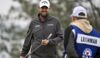 Marc Leishman, of Australia, smiles after putting on the fourth hole of the South Course at Torrey Pines Golf Course during the final round of the Farmers Insurance golf tournament Sunday, Jan. 26, 2020, in San Diego. (AP Photo/Denis Poroy)