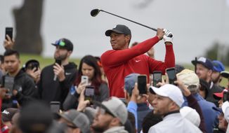 Tiger Woods watches his tee shot on the second hole of the South Course at Torrey Pines Golf Course during the final round of the Farmers Insurance golf tournament Sunday, Jan. 26, 2020, in San Diego. (AP Photo/Denis Poroy)