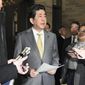 Japanese Prime Minister Shinzo Abe, center, speaks to reporters at his official residence in Tokyo Sunday, Jan. 26, 2020. Abe said he is making arrangements to fly Japanese people home from the Chinese city of Wuhan, hit by an outbreak of a new virus recently. (Mizuki Ikari/Kyodo News via AP)