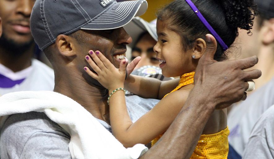In this June 14, 2009, photo, Los Angles Lakers guard Kobe Bryant celebrates with his daughter Gianna, following the Lakers 99-86 defeat of the Orlando Magic in Game 5 of the NBA Finals at Amway Arena in Orlando. (Stephen M. Dowell/Orlando Sentinel via AP) ** FILE **