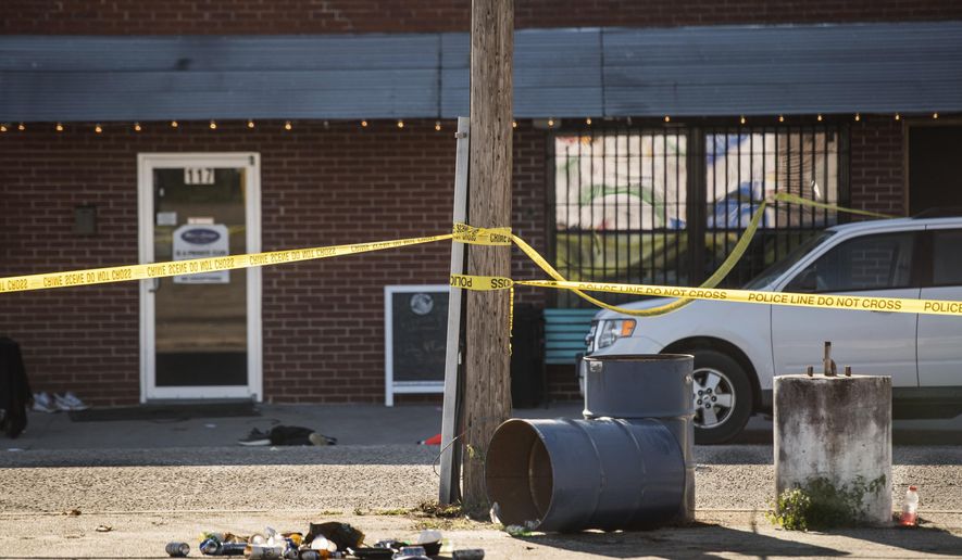 Crime scene tape stretches in front of Mac's Lounge, the scene of an early morning bar shooting, Sunday, Jan. 26, 2020, in Hartsville, S.C. (AP Photo/Sean Rayford)