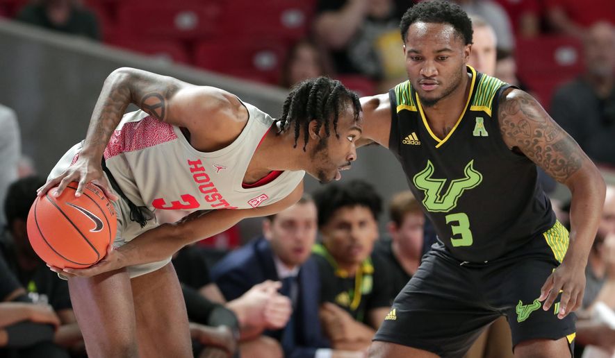 Houston guard DeJon Jarreau (3) looks for a way around South Florida guard Laquincy Rideau (3) during the first half of an NCAA college basketball game Sunday, Jan. 26, 2020, in Houston. (AP Photo/Michael Wyke)
