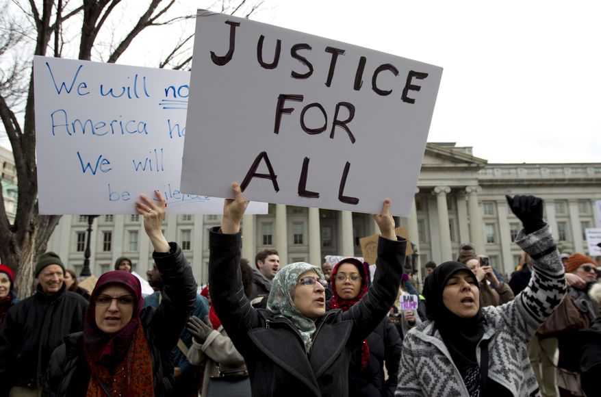 FILE - In this Jan. 29, 2017 file photo, demonstrators carrying signs chant as they protest outside of the White House in Washington during a demonstration to denounce President Donald Trump's executive order banning travel to the U.S. by citizens of Iraq, Syria, Iran, Sudan, Libya, Somalia and Yemen. Trump's travel ban on travelers from predominantly Muslim countries is headed back to a federal appeals court, three years after it was first imposed. On Tuesday, Jan. 27, 2020, the 4th U.S. Circuit Court of Appeals in Richmond is scheduled to hear arguments in three lawsuits filed by U.S. citizens and permanent residents whose relatives have been unable to enter the U.S. because of the ban. (AP Photo/Jose Luis Magana, File)