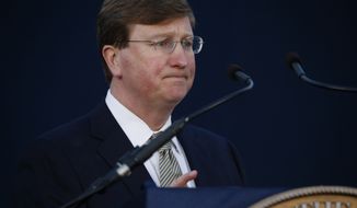 Gov. Tate Reeves pauses as he delivers his State of the State address before a joint session of the Legislature, seated outside the Capitol in Jackson, Miss., Monday, Jan. 27, 2020. (AP Photo/Rogelio V. Solis)