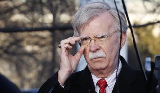 In this March 5, 2019, file photo, then-National Security Adviser John Bolton adjusts his glasses before an interview at the White House in Washington. (AP Photo/Jacquelyn Martin) ** FILE **