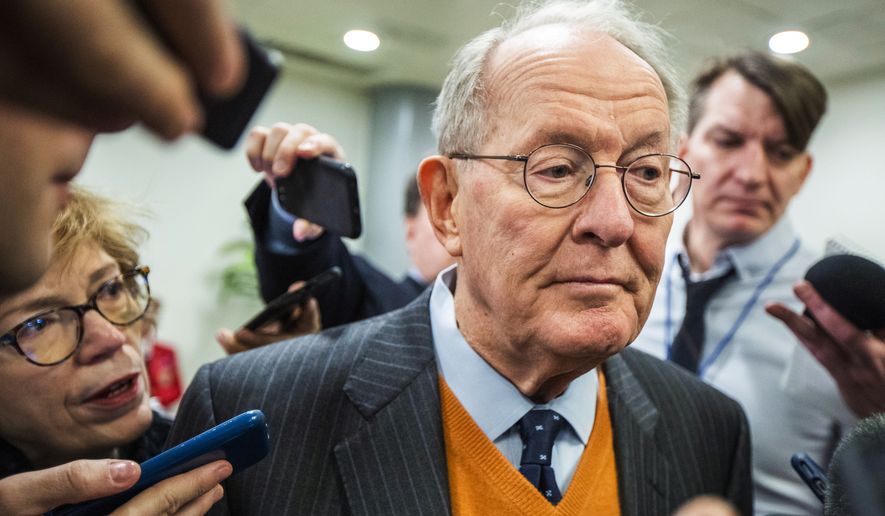 Sen. Lamar Alexander, R-Tenn., speaks to reporters as he arrives at the Capitol in Washington, Monday, Jan. 27, 2020, during the impeachment trial of President Donald Trump on charges of abuse of power and obstruction of Congress. (AP Photo/Manuel Balce Ceneta)