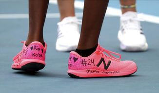 United States&#39; Coco Gauff, front, and compatriot Caty McNally wear a tribute to Kobe Bryant on their shoes during their doubles match against Japan&#39;s Shuko Aoyama amd Ena Shibahara at the Australian Open tennis championship in Melbourne, Australia, Monday, Jan. 27, 2020. (AP Photo/Dita Alangkara)