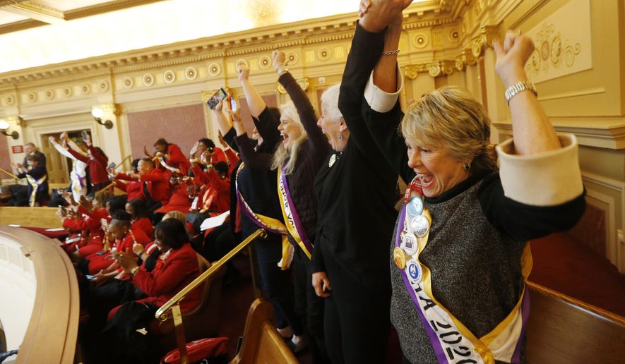 Equal Rights Amendment supporter Donna Granski, right, from Midlothian Va., cheers the passage of the House ERA Resolution in the Senate chambers at the Capitol in Richmond, Va. Monday, Jan. 27, 2020. The resolution passed 27-12. (AP Photo/Steve Helber)