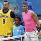 Australia&#39;s Nick Kyrgios, left, poses for a photo with Rafael Nadal, wearing a shirt as a tribute to Kobe Bryant ahead of his fourth round singles match at the Australian Open tennis championship in Melbourne, Australia, Monday, Jan. 27, 2020. (AP Photo/Lee Jin-man)