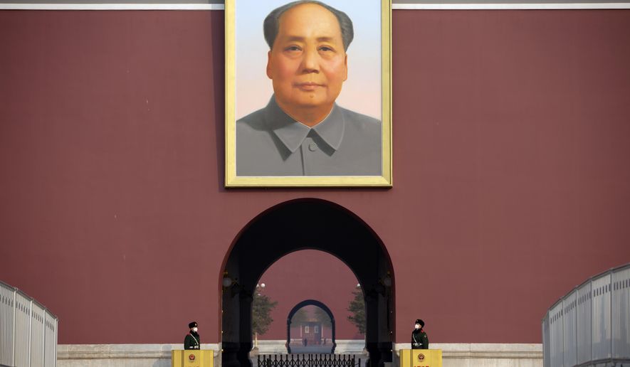 In this file photo, Chinese paramilitary police wear face masks as they stand guard beneath the large portrait of Chinese leader Mao Zedong at Tiananmen Gate adjacent to Tiananmen Square in Beijing, Monday, Jan. 27, 2020.  (AP Photo/Mark Schiefelbein)