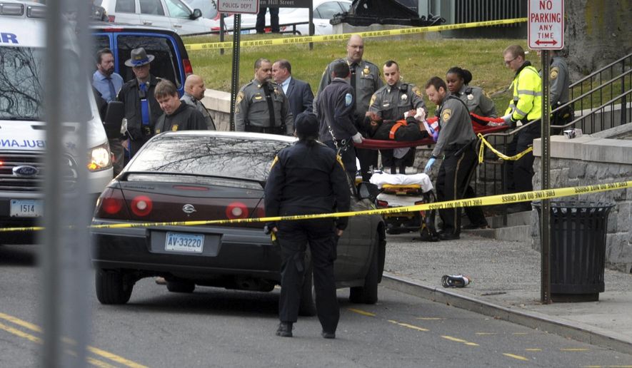 Emergency personnel respond to a shooting outside at he Golden Hill Street courthouse Bridgeport, Conn., Monday, Jan. 27, 2020. Bridgeport's director of Emergency Management and Homeland Security tells the Connecticut Post that the preliminary report is that three people were shot just after noon Monday outside Bridgeport Superior Court on Golden Hill Street. He said there is no immediate threat to the public. (Ned Gerard /Hearst Connecticut Media via AP)
