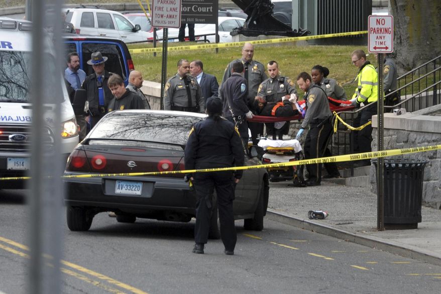 Emergency personnel respond to a shooting outside at he Golden Hill Street courthouse Bridgeport, Conn., Monday, Jan. 27, 2020. Bridgeport's director of Emergency Management and Homeland Security tells the Connecticut Post that the preliminary report is that three people were shot just after noon Monday outside Bridgeport Superior Court on Golden Hill Street. He said there is no immediate threat to the public. (Ned Gerard /Hearst Connecticut Media via AP)