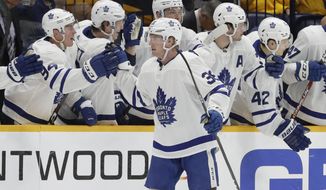 Toronto Maple Leafs defenseman Rasmus Sandin (38), of Sweden, is congratulated after scoring a goal against the Nashville Predators in the second period of an NHL hockey game Monday, Jan. 27, 2020, in Nashville, Tenn. (AP Photo/Mark Humphrey)