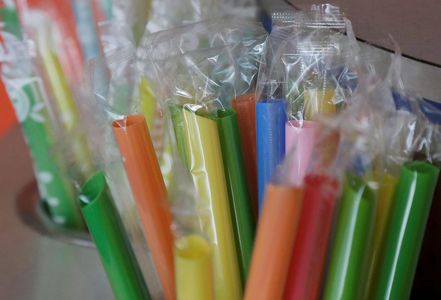 This July 17, 2018 file photo shows wrapped plastic straws at a bubble tea cafe in San Francisco. On Wednesday, the Oregon House or Representatives voted to prohibit restaurants from providing single-use plastic straws unless a customer asks. Drive-thrus could still offer straws, as could health care facilities. California previously passed limits on plastic straws. (AP Photo/Jeff Chiu, File) **FILE**