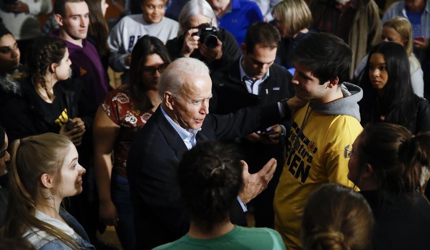 Democratic presidential candidate former Vice President Joe Biden meets with attendees during a campaign event, Monday, Jan. 27, 2020, in Iowa City, Iowa. (AP Photo/Matt Rourke)